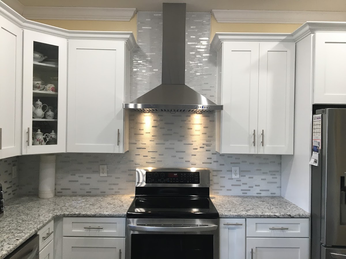 Kitchen remodel with white cabinets and mosaic backsplash
